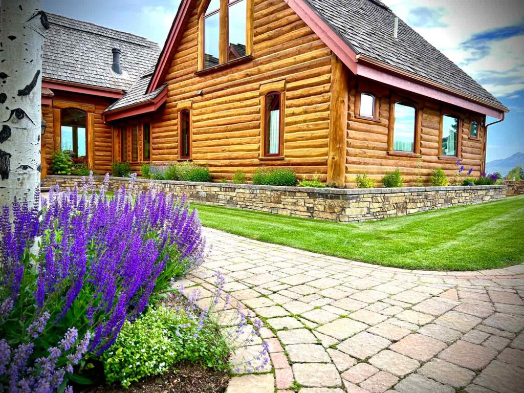 Log home with lupine and manicured lawn in Jackson Hole
