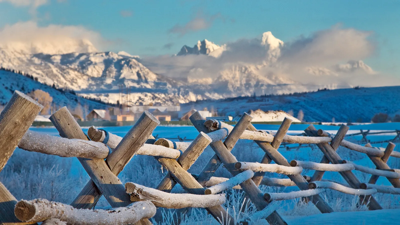 Snow-covered pasture and buck-rail fence in Jackson Hole after a winter storm